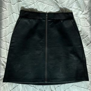 Black faux leather skirt with front zipper detail